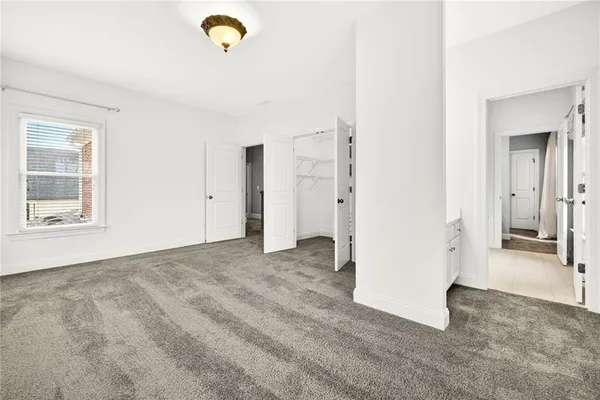 a front view of a house with a tree