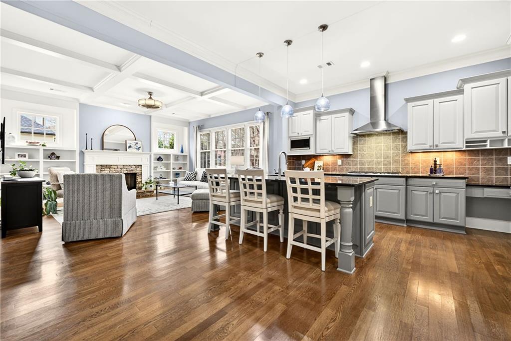 455 High Pointe Trail Roswell, GA 30076 - Photo 10 of 46 a living room with stainless steel appliances kitchen island granite countertop furniture and a wooden floor
