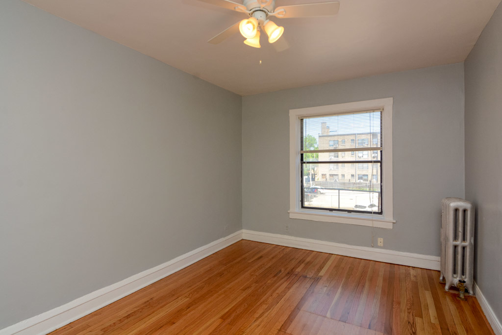 4606 North Beacon Street, Unit 2B Chicago, IL 60640 - Photo 14 of 20 an empty room with wooden floor and windows