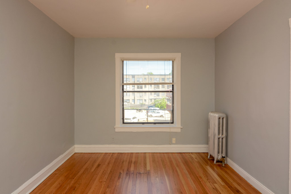 4606 North Beacon Street, Unit 2B Chicago, IL 60640 - Photo 15 of 20 an empty room with window and wooden floor