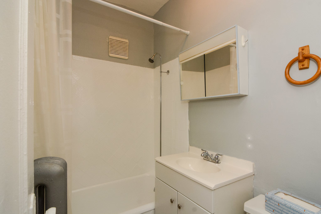 4606 North Beacon Street, Unit 2B Chicago, IL 60640 - Photo 17 of 20 a bathroom with a sink toilet and a mirror