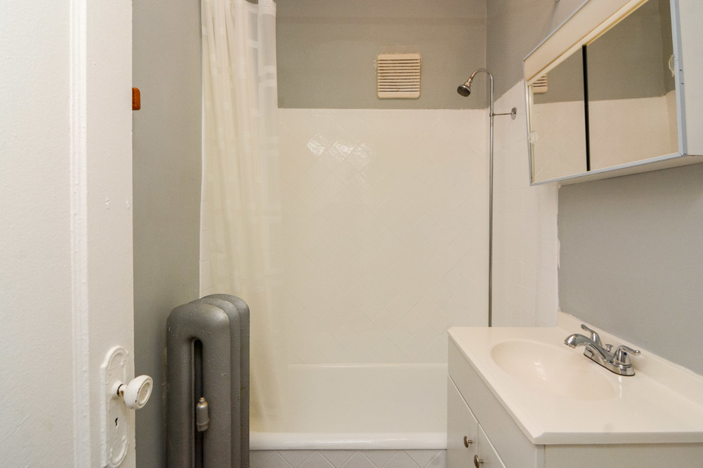 4606 North Beacon Street, Unit 2B Chicago, IL 60640 - Photo 18 of 20 a bathroom with a sink and a mirror