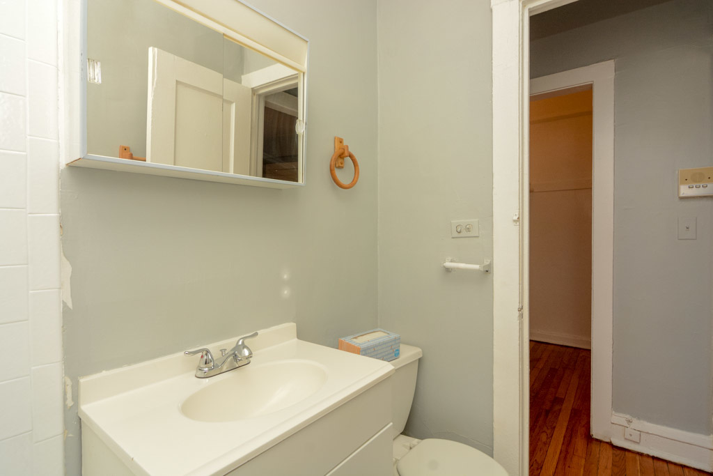 4606 North Beacon Street, Unit 2B Chicago, IL 60640 - Photo 19 of 20 a bathroom with a sink mirror and toilet