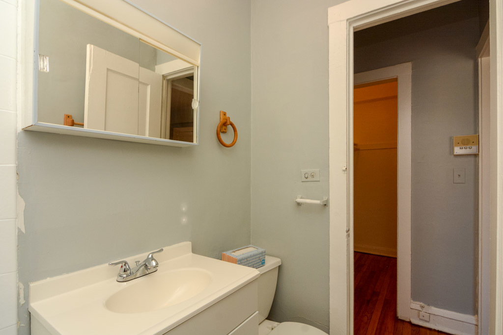 4606 North Beacon Street, Unit 2B Chicago, IL 60640 - Photo 20 of 20 a bathroom with a sink and mirror with toilet