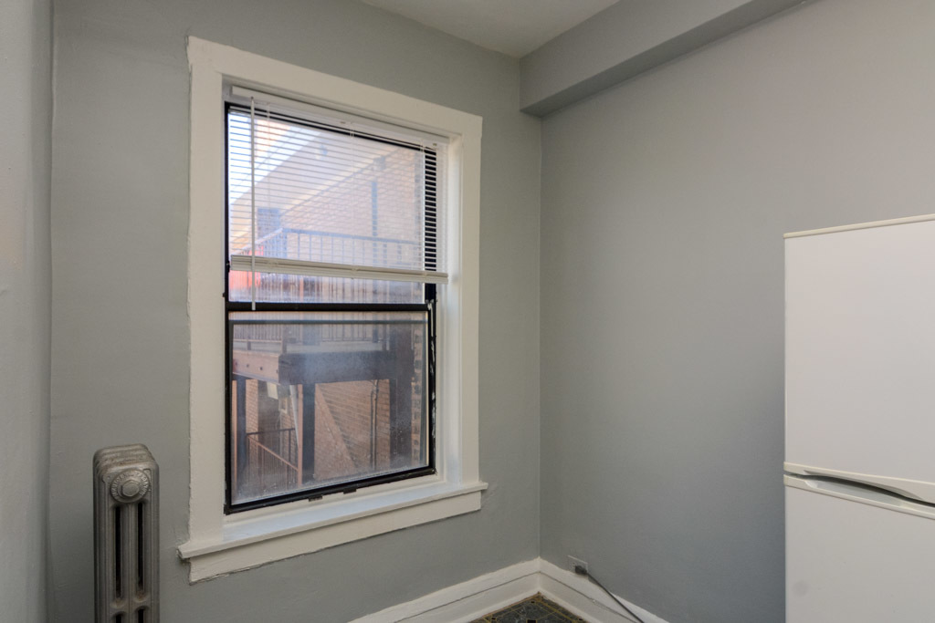 4606 North Beacon Street, Unit 2B Chicago, IL 60640 - Photo 6 of 20 a view of an empty room with wooden floor and a window
