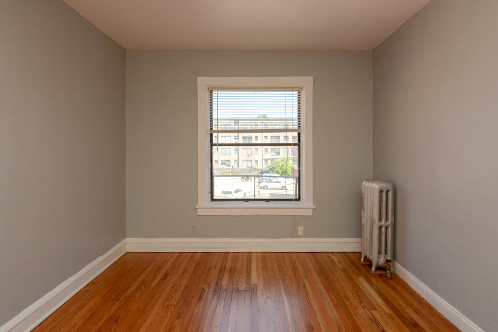 4606 North Beacon Street, Unit 2B Chicago, IL 60640 - Photo 7 of 20 an empty room with wooden floor and windows
