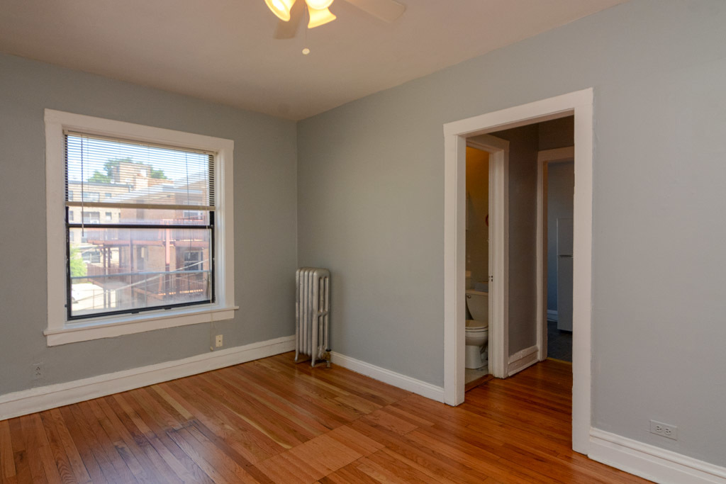 4606 North Beacon Street, Unit 2B Chicago, IL 60640 - Photo 8 of 20 an empty room with wooden floor closet and windows