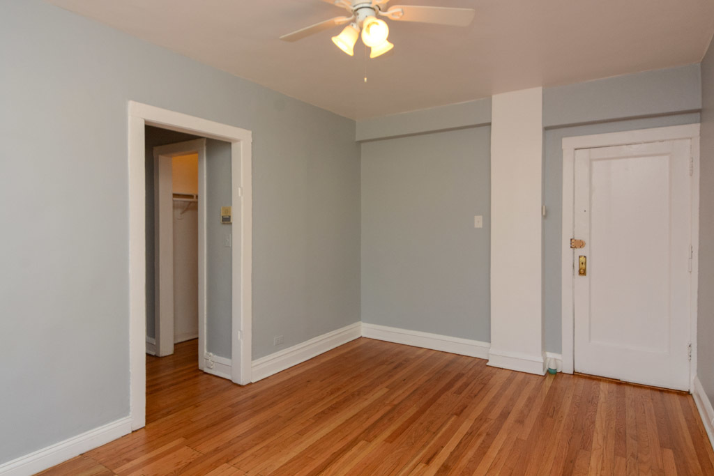 4606 North Beacon Street, Unit 2B Chicago, IL 60640 - Photo 10 of 20 a view of a room with wooden floor and a ceiling fan