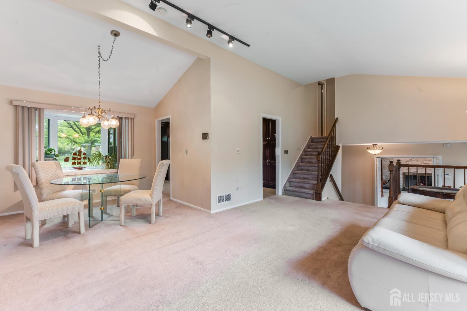 12 Sullivan Way East Brunswick, NJ 08816 - Photo 14 of 40 a living room with furniture and a chandelier