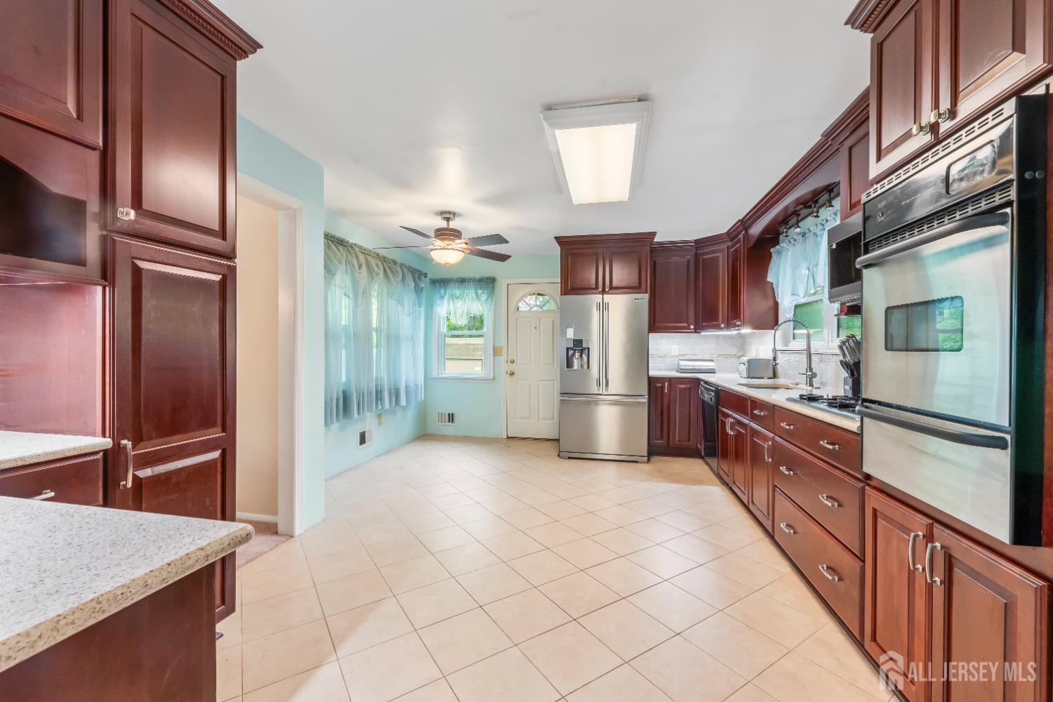 12 Sullivan Way East Brunswick, NJ 08816 - Photo 17 of 40 a large kitchen with stainless steel appliances kitchen island granite countertop a refrigerator and a sink