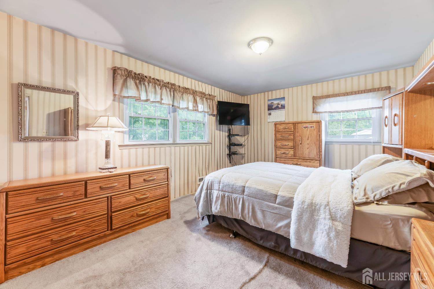 12 Sullivan Way East Brunswick, NJ 08816 - Photo 26 of 40 a bedroom with a bed and large windows