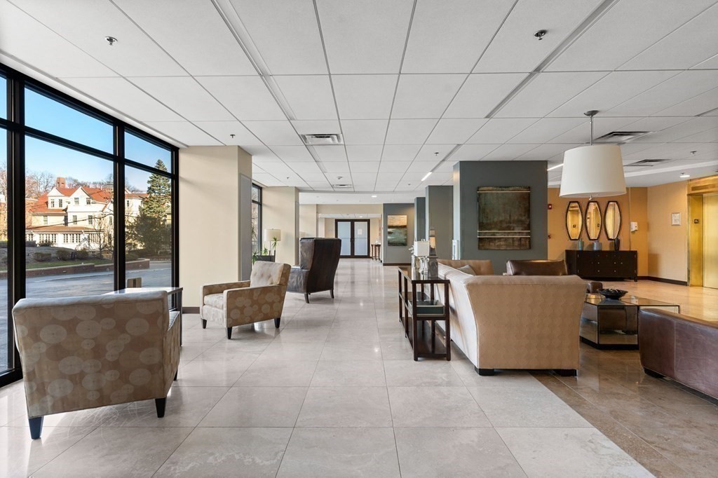 60 Longwood Avenue, Unit 802 Brookline, MA 02446 - Photo 11 of 16 a living room with furniture and a flat screen tv