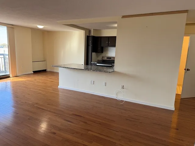 a view of a kitchen with wooden floor and a sink
