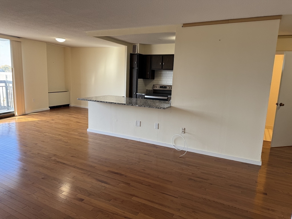 60 Longwood Avenue, Unit 802 Brookline, MA 02446 - Photo 7 of 16 a view of a kitchen with wooden floor and a sink