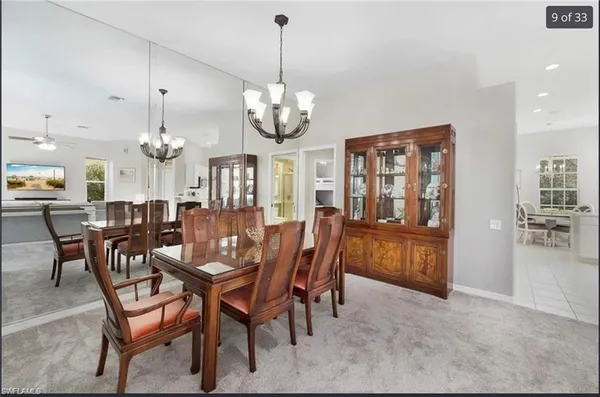 a view of a dining room with furniture and chandelier