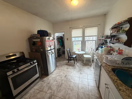 a kitchen with a stove and a refrigerator