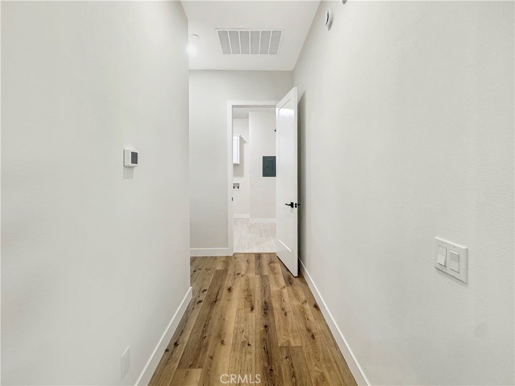 30233 Del Rey Road Temecula, CA 92591 - Photo 43 of 64 a view of a hallway with wooden floor