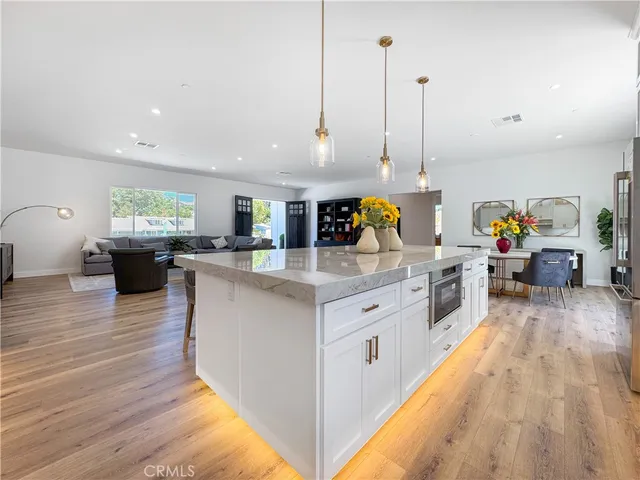 a living room with furniture and a kitchen area