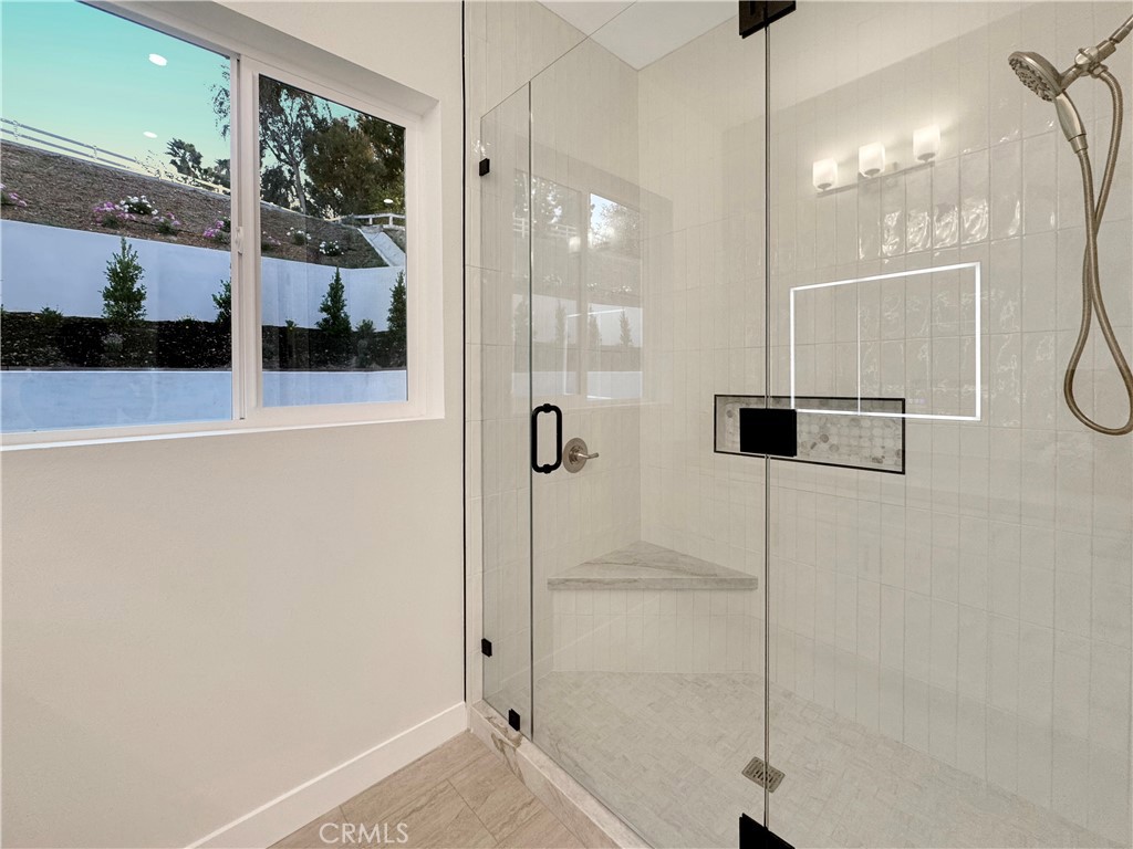 30233 Del Rey Road Temecula, CA 92591 - Photo 52 of 64 a bathroom with a shower and a glass door