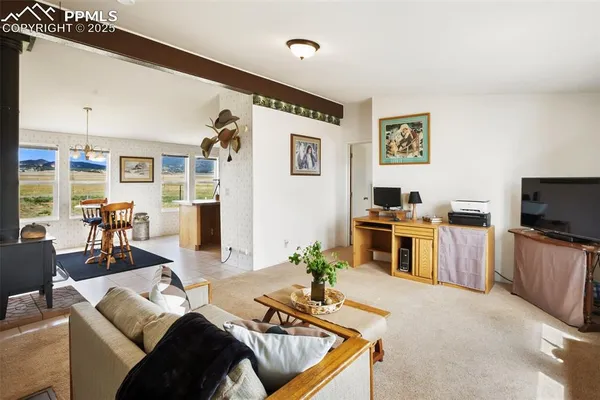 a large kitchen with stainless steel appliances granite countertop a sink dishwasher a dining table and chairs with wooden floor