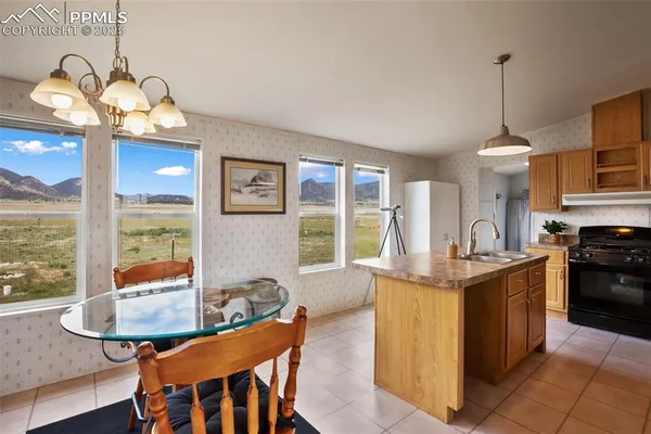 a kitchen with a sink a stove and cabinets