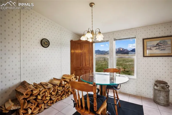 a kitchen with a sink a counter and chairs