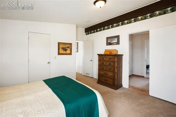 a bedroom with a bed and chair