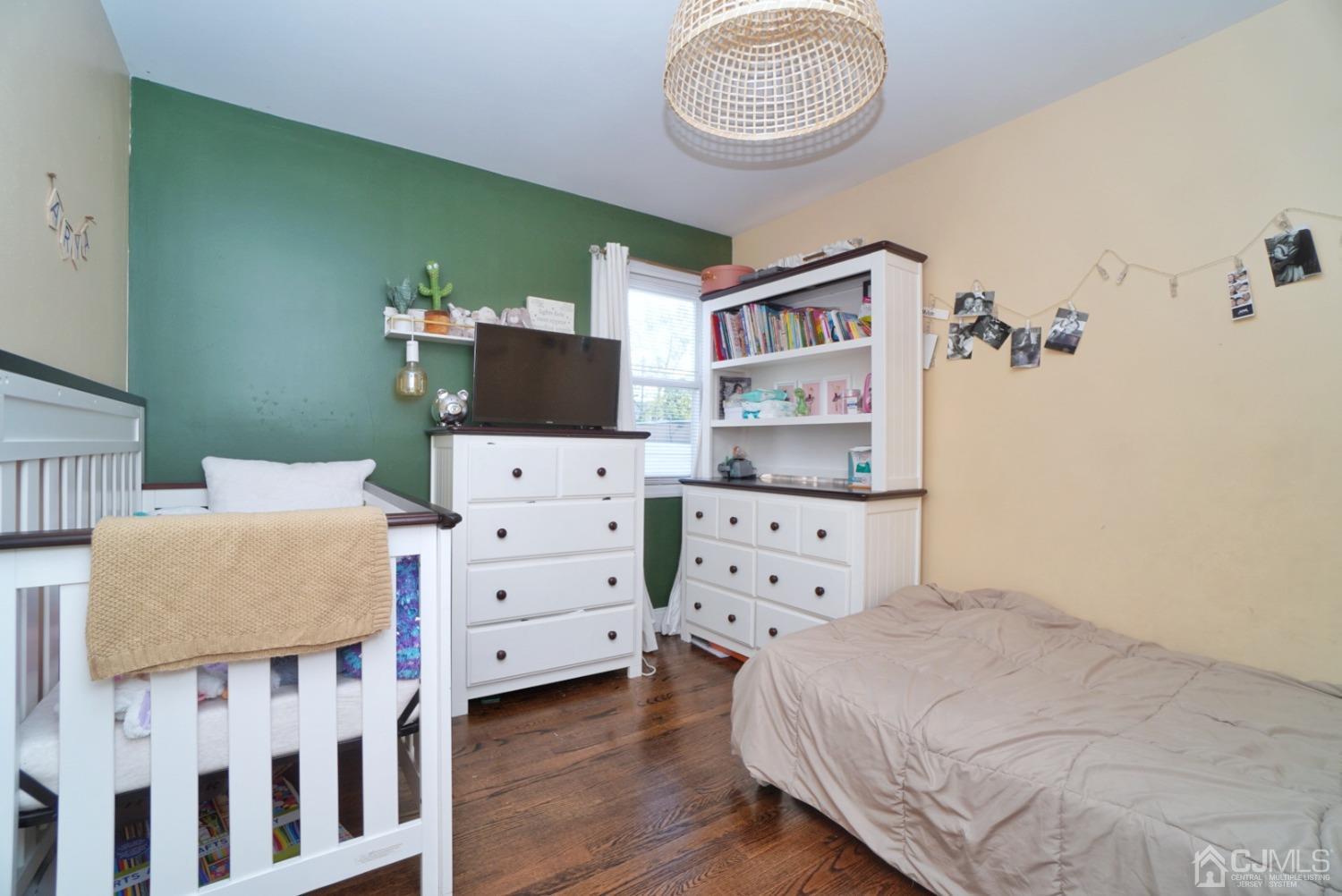 379 Summit Avenue Perth Amboy, NJ 08861 - Photo 11 of 22 a bedroom with a bed and wooden floor