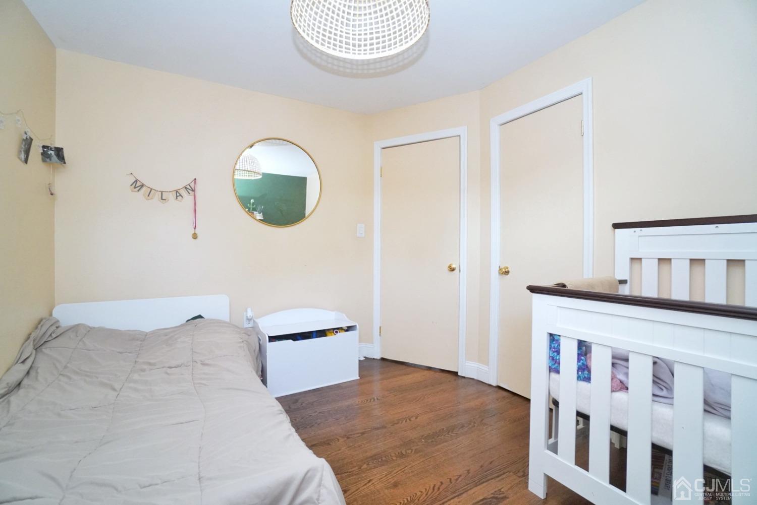 379 Summit Avenue Perth Amboy, NJ 08861 - Photo 12 of 22 a bedroom with a bed and a painting on the wall