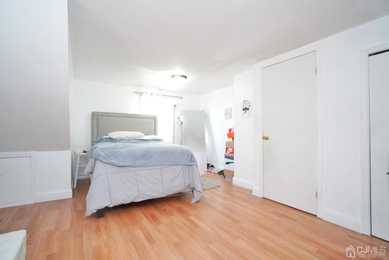 379 Summit Avenue Perth Amboy, NJ 08861 - Photo 15 of 22 a bedroom with a bed and wooden floor