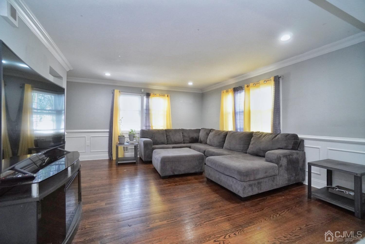 379 Summit Avenue Perth Amboy, NJ 08861 - Photo 5 of 22 a living room with furniture and a flat screen tv