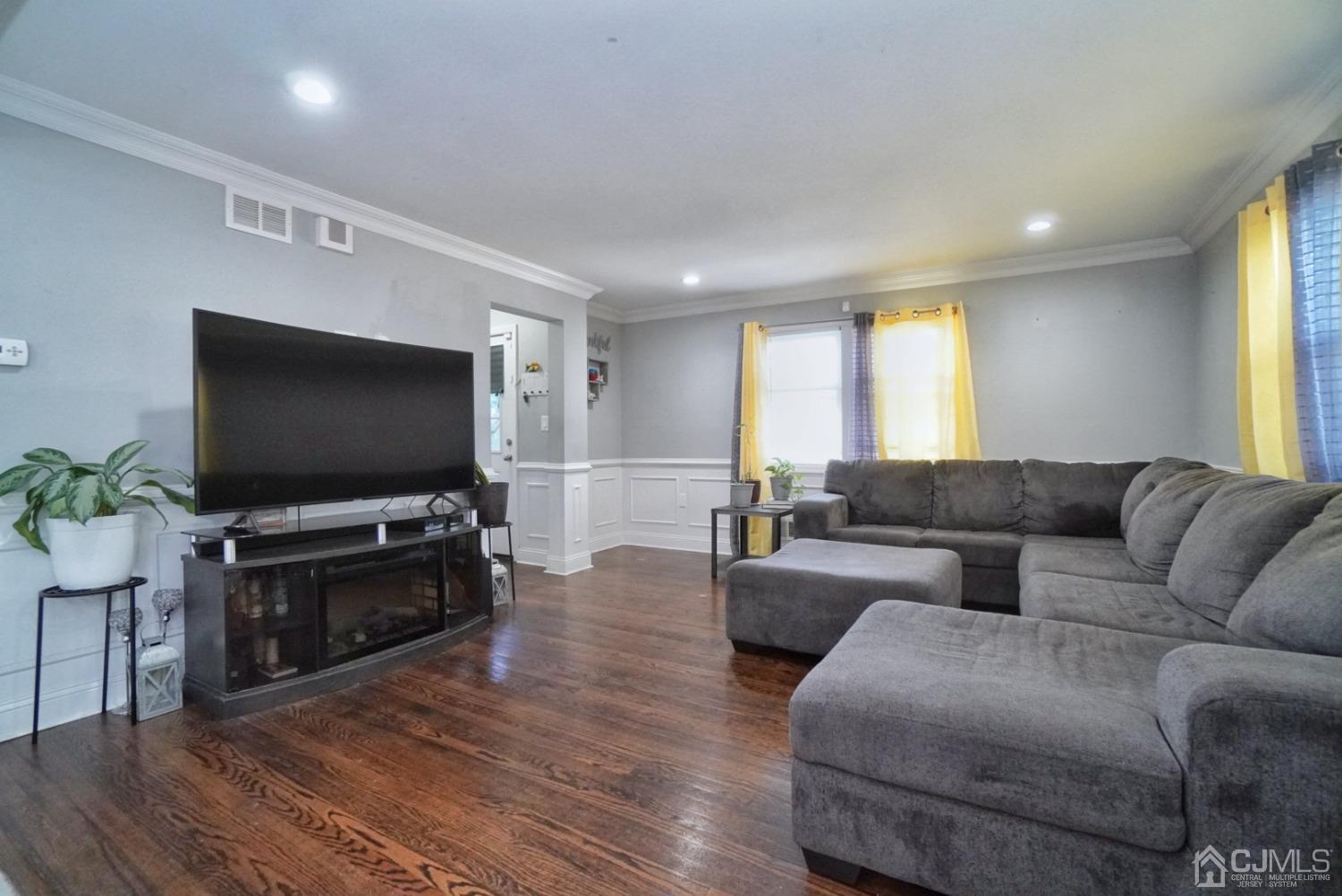 379 Summit Avenue Perth Amboy, NJ 08861 - Photo 6 of 22 a living room with furniture and a flat screen tv