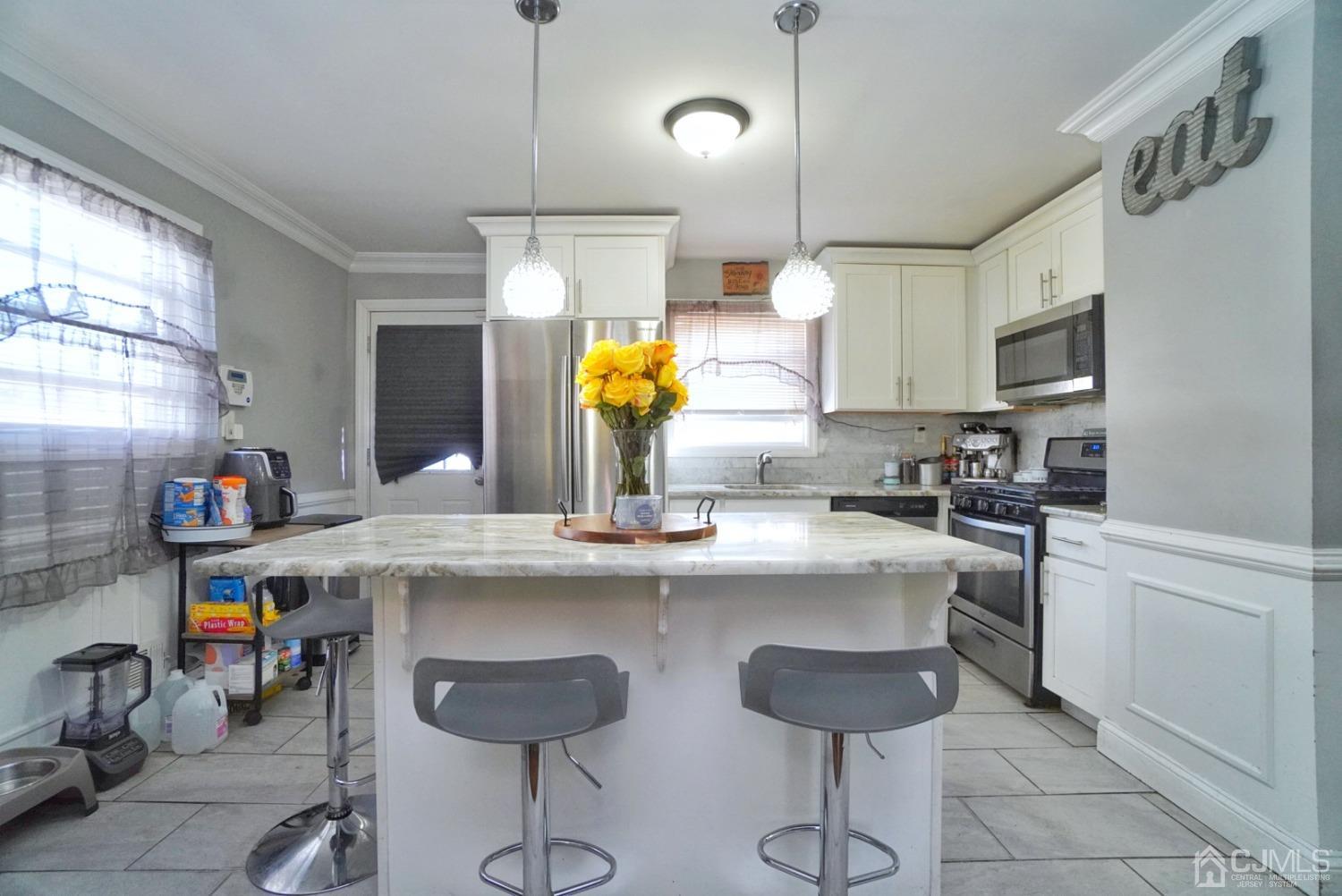 379 Summit Avenue Perth Amboy, NJ 08861 - Photo 7 of 22 a kitchen with stainless steel appliances a sink and cabinets