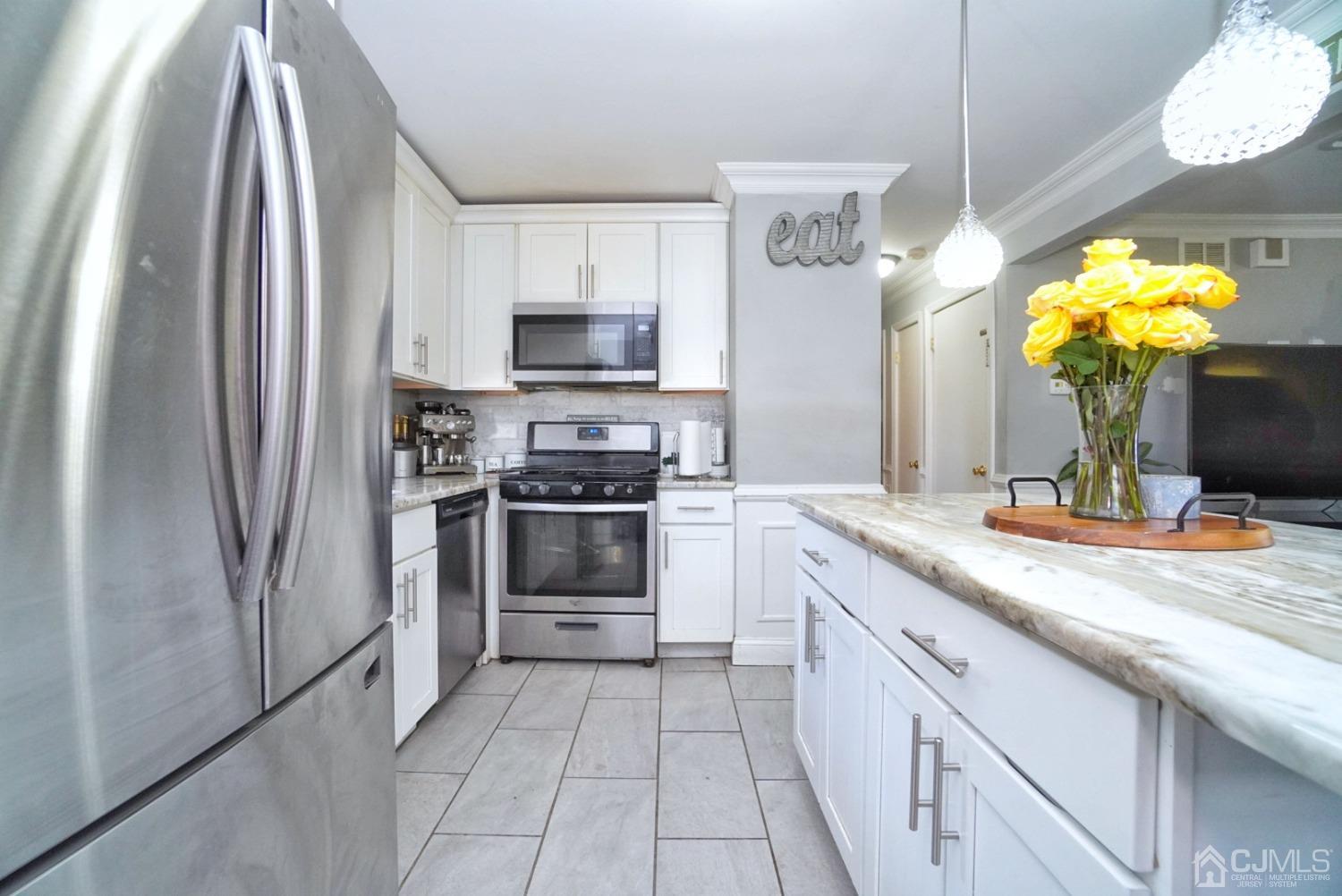 379 Summit Avenue Perth Amboy, NJ 08861 - Photo 8 of 22 a kitchen with stainless steel appliances granite countertop a sink a refrigerator and a stove