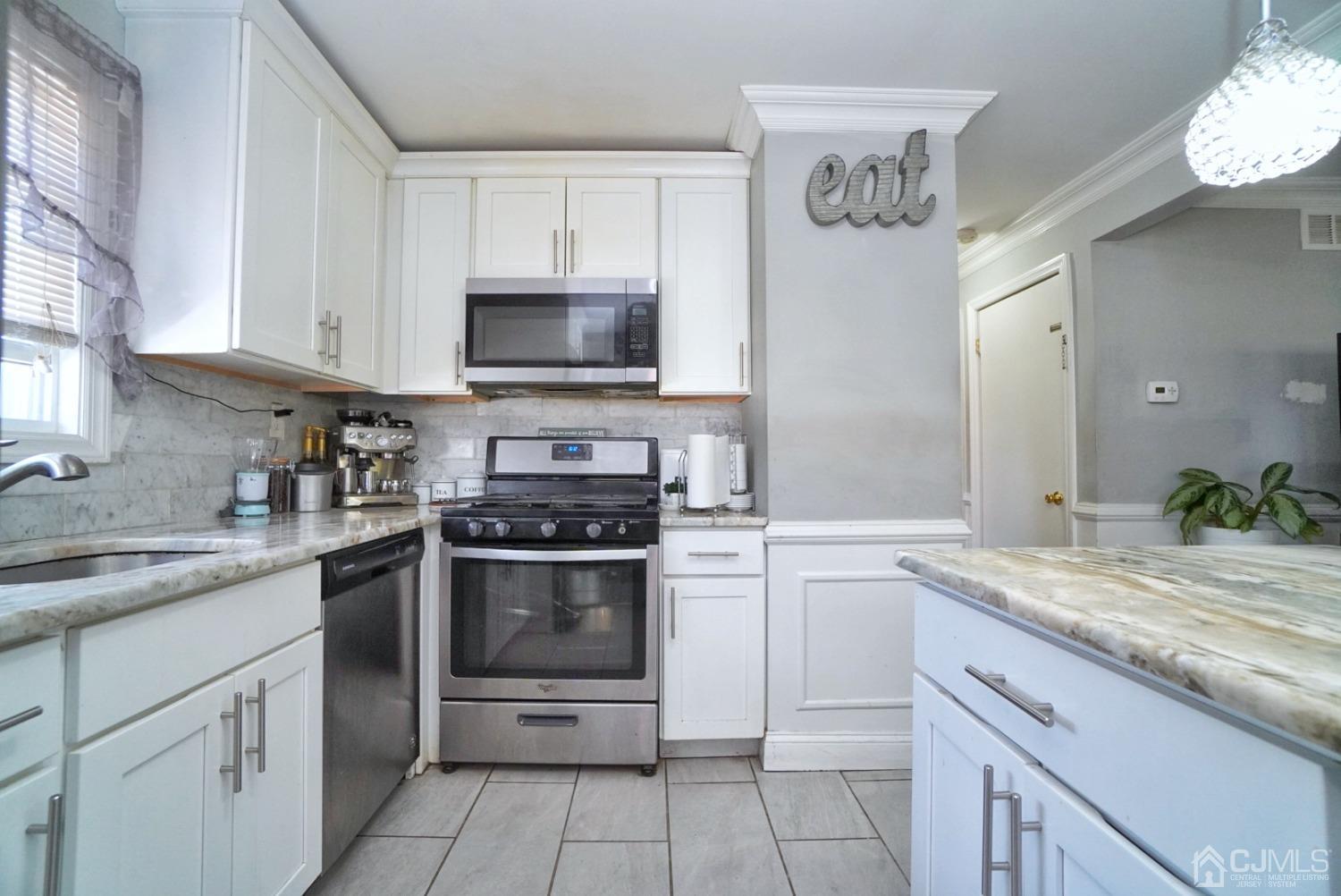 379 Summit Avenue Perth Amboy, NJ 08861 - Photo 9 of 22 a kitchen with cabinets stainless steel appliances and a sink
