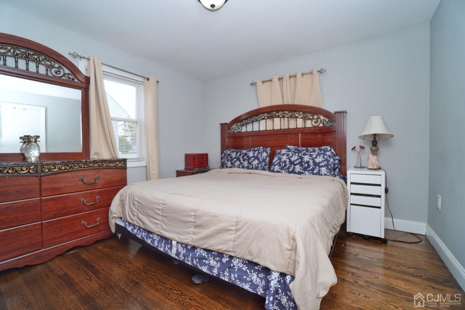 379 Summit Avenue Perth Amboy, NJ 08861 - Photo 10 of 22 a bedroom with a bed and a dresser