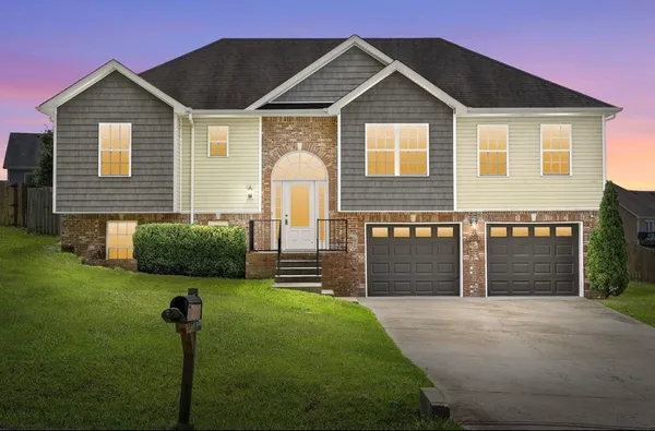 a front view of a house with a yard and garage