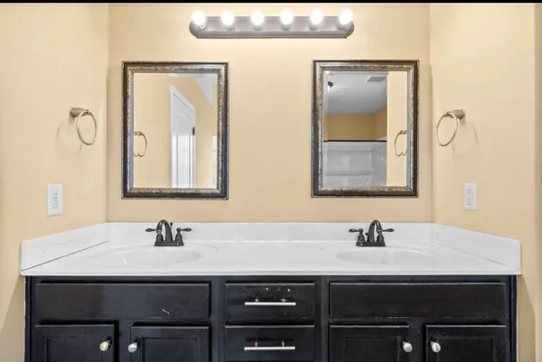 a bathroom with a sink and a mirror