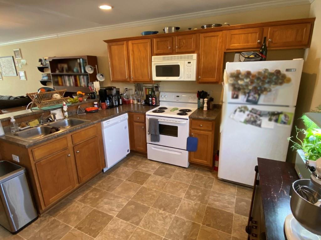 232 Epps Bridge Road, Unit 1A Athens, GA 30606 - Photo 4 of 14 a kitchen with stainless steel appliances granite countertop a stove top oven a sink a refrigerator and a microwave