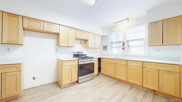 a kitchen with stainless steel appliances granite countertop a sink and cabinets with wooden floor