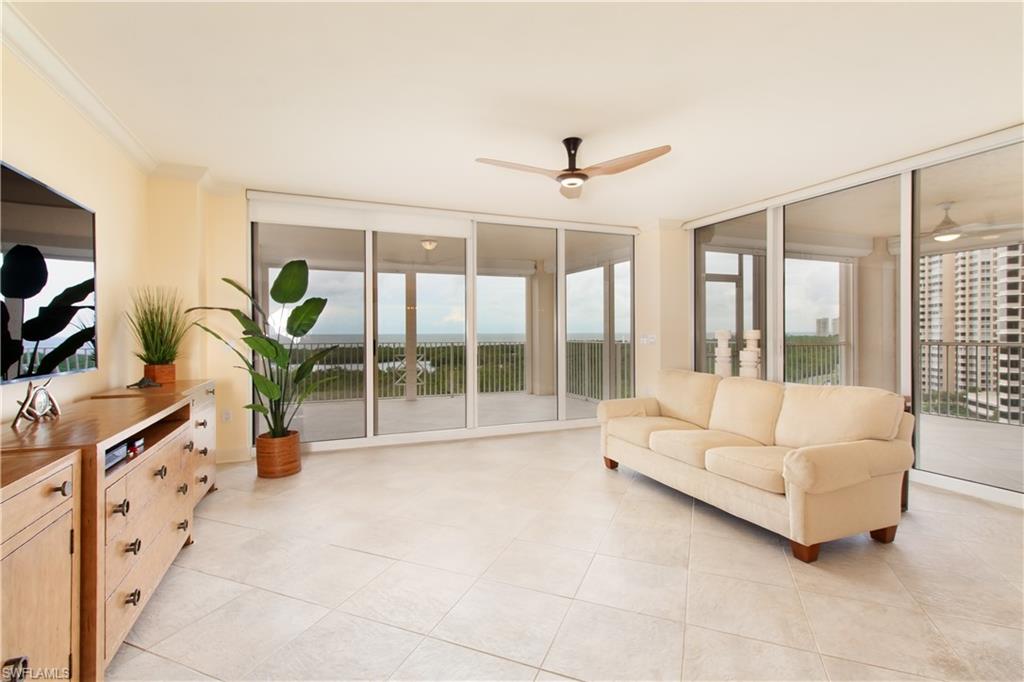 a living room with furniture and large windows
