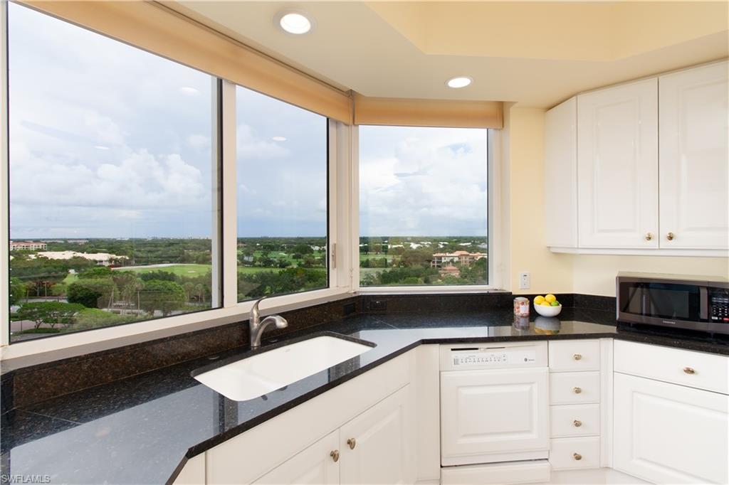 6597 Nicholas Boulevard, Unit 1006 Naples, FL 34108 - Photo 4 of 6 a kitchen with a large window a sink and cabinets