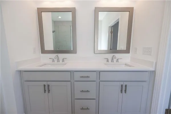 a bathroom with a double vanity sink mirror and