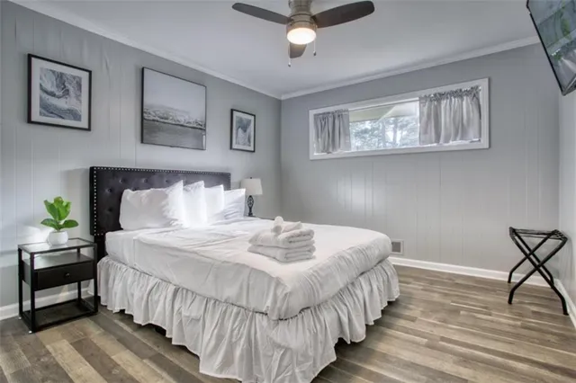 a bedroom with bed and a chandelier