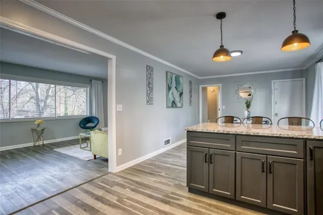 a view of kitchen with granite countertop a sink and a stove
