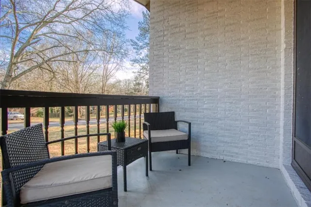 a view of a balcony with chairs