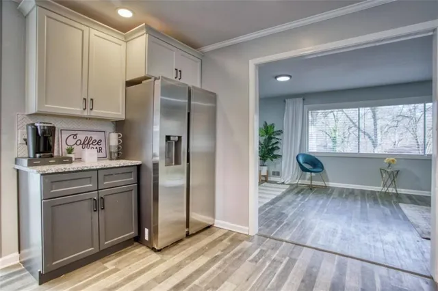 a kitchen with a refrigerator a sink and cabinets