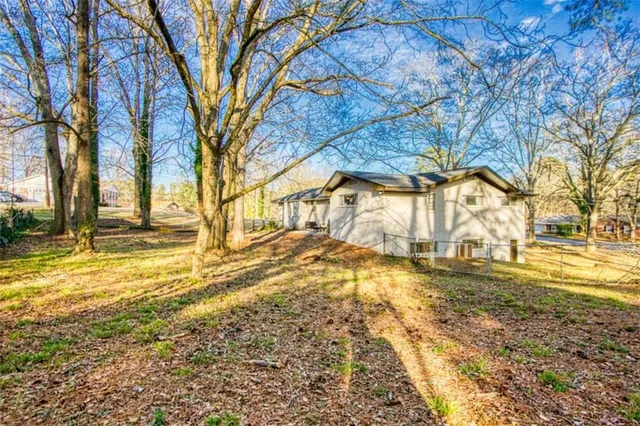 a view of yard with large trees