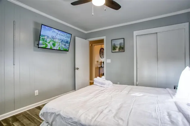 a bedroom with a large bed and a chandelier