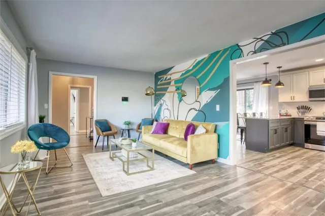 a living room with furniture and wooden floor